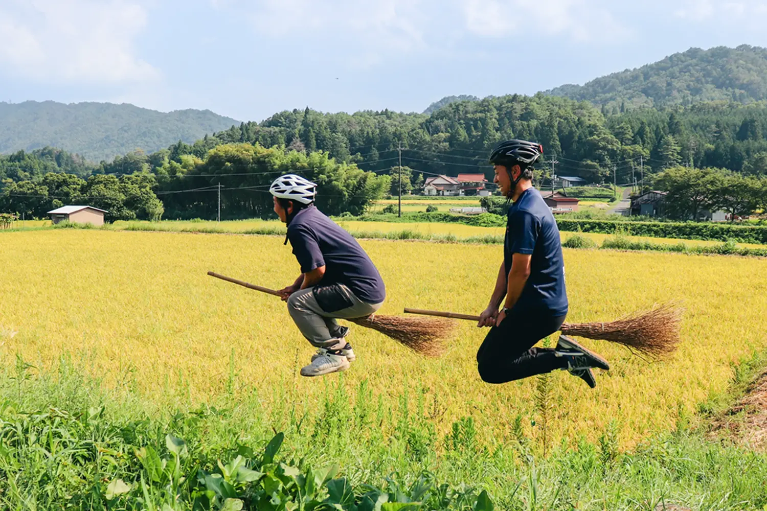 田とほうきにまたがりジャンプする人